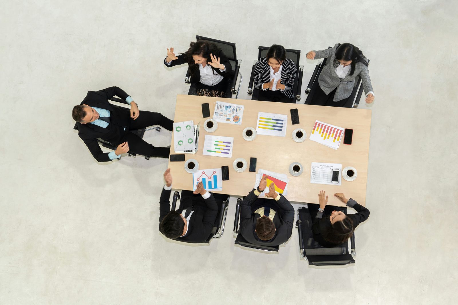 Overhead view of a tense conference room meeting.