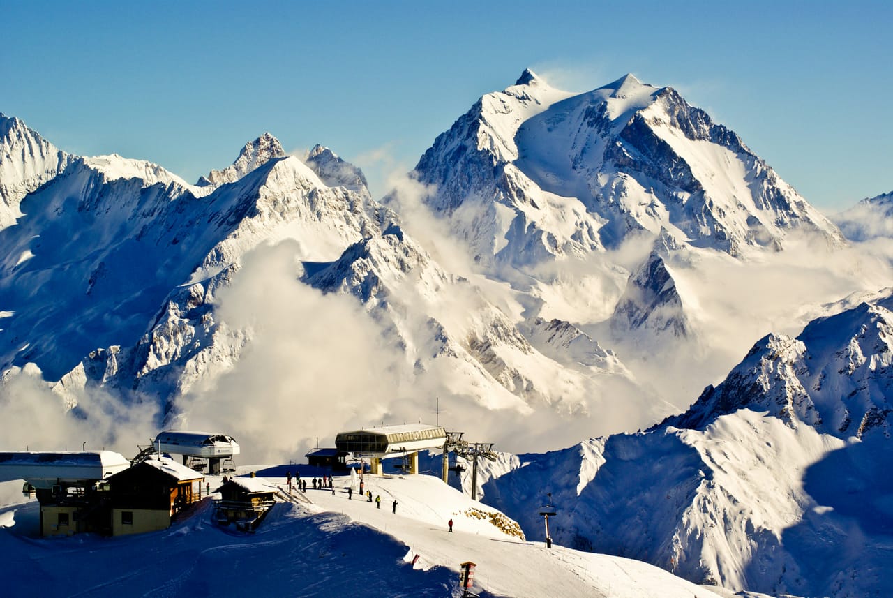 Snow-capped alpine peaks under a clear sky