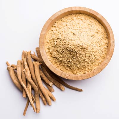 Image shows a wooden bowl containing ashwagandha in powdered form